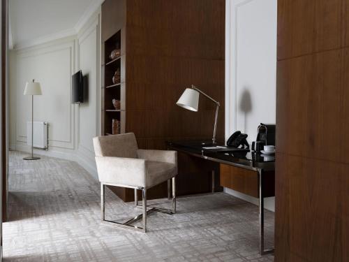 a desk with a chair and a lamp in a room at Mercure Tashkent in Tashkent