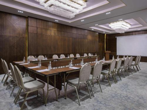 a large conference room with a long table and chairs at Mercure Tashkent in Tashkent