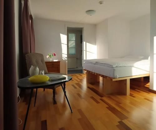 a bedroom with a bed and a table and a chair at Krone Trogen in Trogen