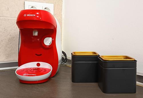 a red blender sitting next to a trash can at La Casita de Ale Casa Rural cerca Puy du Fou in Polán
