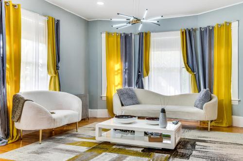 a living room with two chairs and a couch and a table at Classic North End Gem Yard, Patio and Modern Style! in Manchester