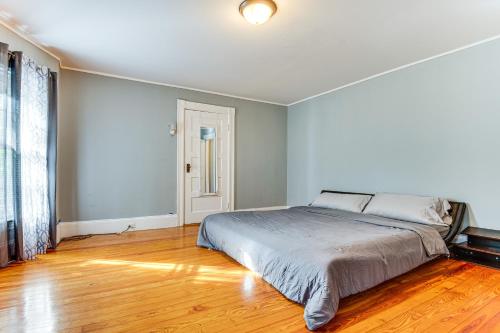 a bedroom with a bed and a wooden floor at Classic North End Gem Yard, Patio and Modern Style! in Manchester