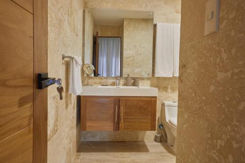 a bathroom with a sink and a mirror at Modern Escape with Pool & Beach in Puerto Plata