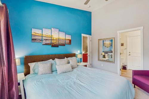 a bedroom with a blue wall and a bed at Happy Valley Hideway in Happy Valley