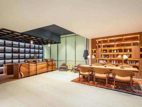 a room with a table and chairs and a library at ibis Bengaluru Hebbal - An Accor Brand in Bengaluru