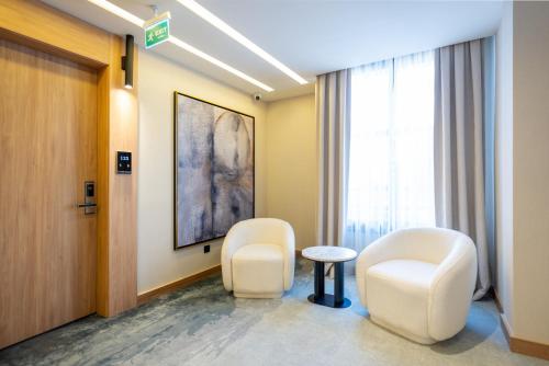 a hospital room with two chairs and a table at Premier Lounge Hotel in Tuzla