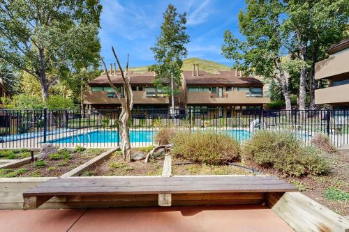 a wooden bench sitting in front of a pool at Remodeled 2 Bedroom East Vail Condo 6G with Hot Tub Market Free Shuttle in Vail