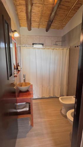 a bathroom with a sink and a toilet at Tulma Cabañas in Volcán