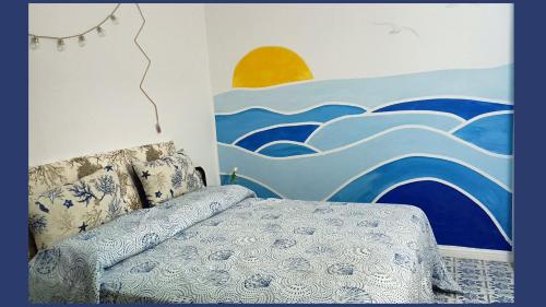 a bedroom with a bed and a painting on the wall at Holiday Home in Lazzaro