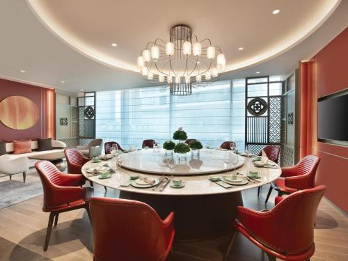 a dining room with a large table and chairs at Pullman Shenzhen North in Shenzhen