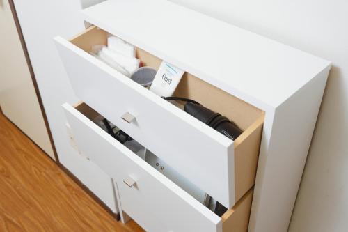 a white dresser drawer with a box at 恵比寿駅から徒歩1分 渋谷3分 新宿10分 30m2でゆったり 最高の立地 302号室 in Tokyo
