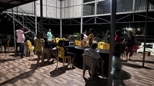a group of people sitting around a table in a building at Tiger Wilderness Lodge, Tadoba in Chimur