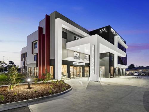 a large modern building with a lit up at Mercure Pakenham in Pakenham