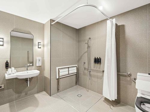 a bathroom with a shower and a sink at Mercure Pakenham in Pakenham