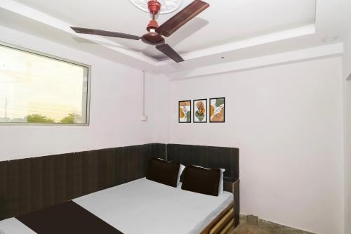 a bed in a room with a ceiling fan at Hotel O Galaxy Inn in Sānkchi