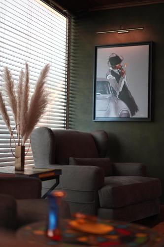 a living room with a couch and a picture of a car at Suites By Le Rêve in Tangier