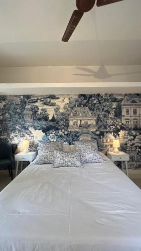 a bedroom with a large bed with a wall mural at THHPSOCIETY - Kahaani boutique Stays - Vagator Goa in Anjuna