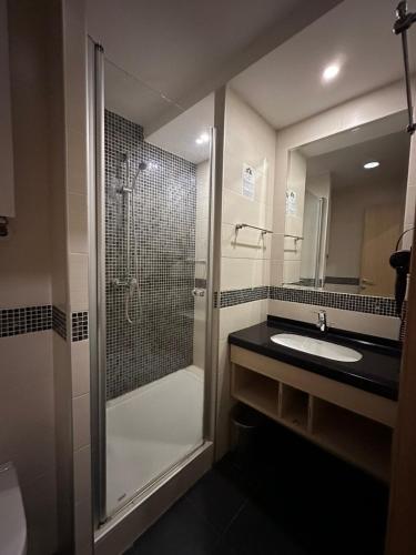 a bathroom with a shower and a sink at Angela 103 in Kopaonik