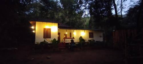 a small house at night with lights on it at Pookie stay athirapilly in Athirappilly