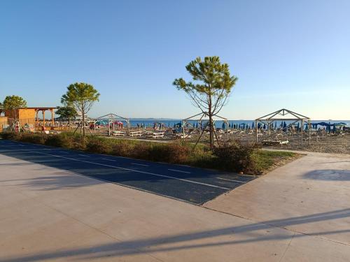 a park with a playground with tables and chairs at NOLO Rooms and Suites in Durrës