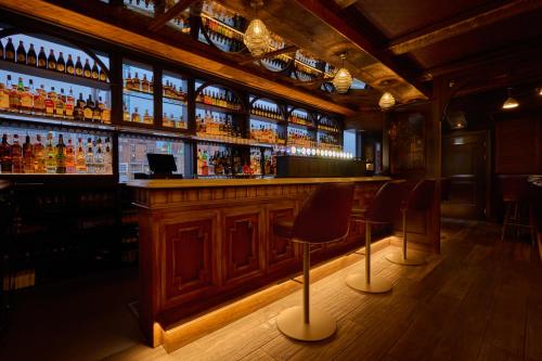a bar with two chairs and a counter with drinks at Wellington Temple Bar in Dublin