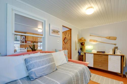 a bedroom with a bed and a desk and a window at Walk to Beach Access! Chic Port Austin Studio in Port Austin