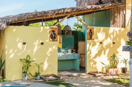 a yellow house with a yellow wall and a counter at Waikiki beach Hotel Boutique in Dibulla