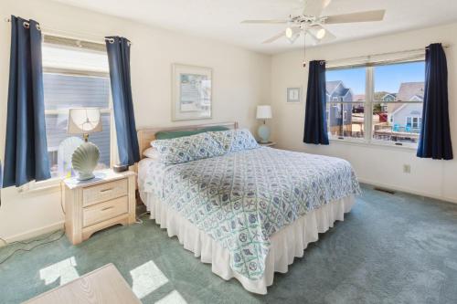 a bedroom with a bed and a window at 6133 - Coastal Crave in Nags Head