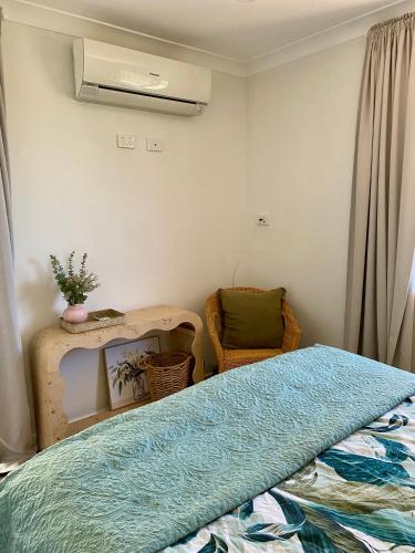a bedroom with a bed and a chair at Modern Stylish House in Craigie in Perth