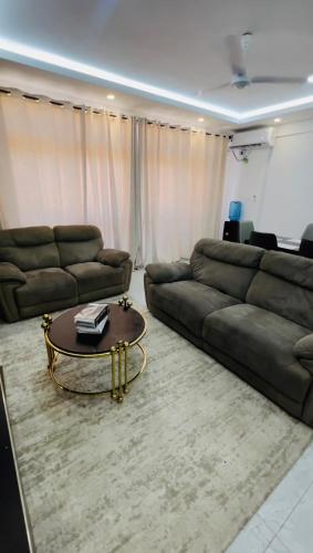a living room with a couch and a coffee table at executive 3-bedroom in Nyali