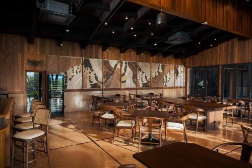 a restaurant with wooden walls and tables and chairs at Sataa Resort Nan in Nan