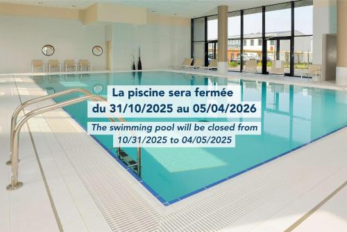 a swimming pool with a sign that reads the swimming pool will be closed from at Residhome Carrières La Défense in Carrières-sur-Seine