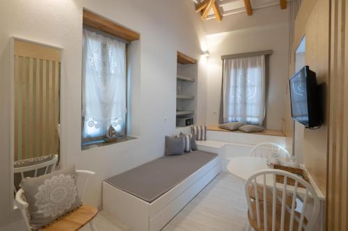 a small living room with a couch and a television at L Anima in Skiathos