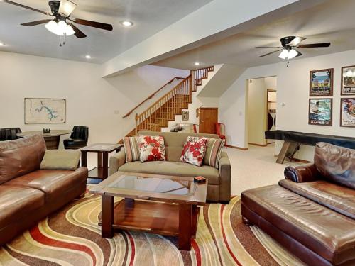 a living room with a couch and a piano at Black Pines Lodge in Hazelhurst