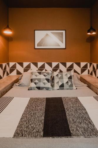 a bedroom with a large bed with a picture on the wall at Casa Sayula Home Cerca De Playa y Centro in Sayulita