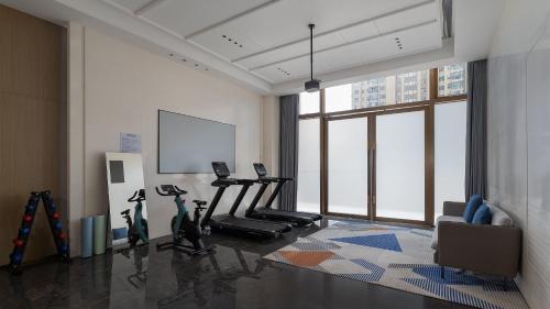 a gym with cardio equipment in a large room at Holiday Inn Express Kunming Economic Dev Zone by IHG in Kunming
