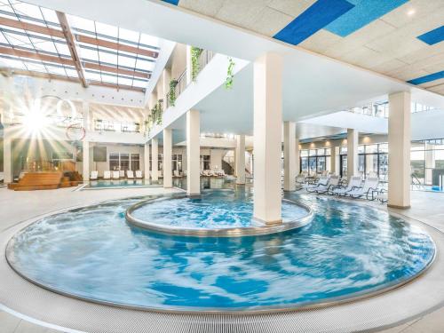a large pool in the middle of a building at Movenpick Resort and Spa Fruske Terme in Vrdnik