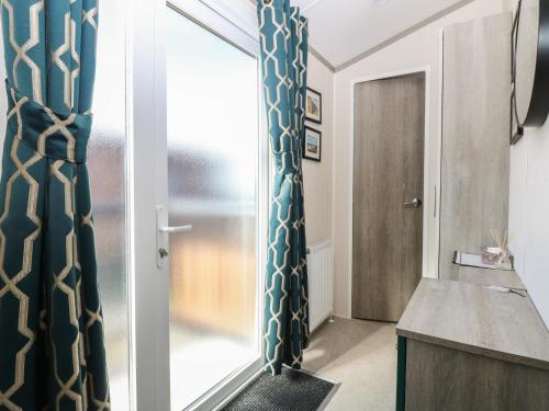 a room with a mirror and a door at Sand & Serenity in Norwich