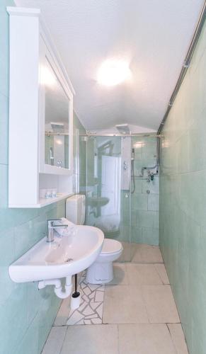 a bathroom with a sink and a toilet and a shower at O'Vascio Sant'Angelo in Serrara Fontana