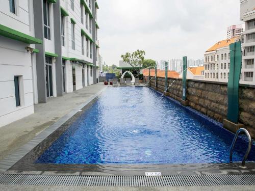 a swimming pool in the middle of a building at ibis Styles Singapore Albert in Singapore