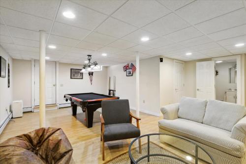 a living room with a pool table and a couch at Northern Lights: 3 br, fireplace, free ski shuttle, a/c, walkable Village location in Stowe