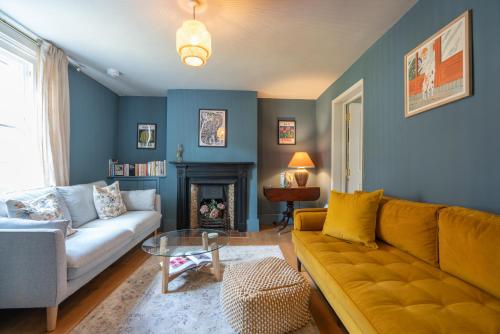 Una sala de estar con un sofá y una chimenea. en Cosy City-Centre House near Train Station & Business School, with Garden, en Oxford