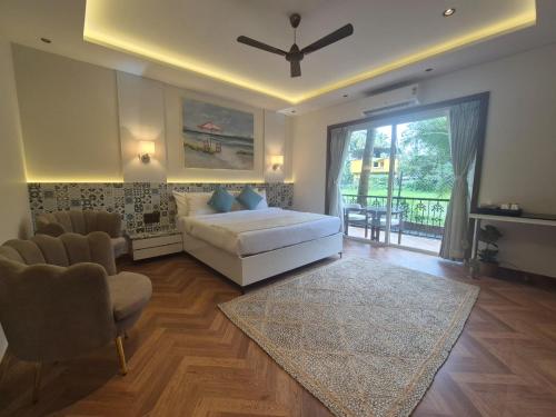 a bedroom with a bed and a living room at Lamrin Morjim Goa in Morjim