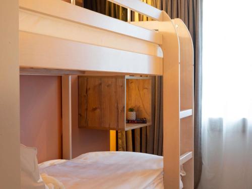 a bunk bed with wooden cabinets in a bedroom at ibis Styles Les Houches Chamonix in Les Houches