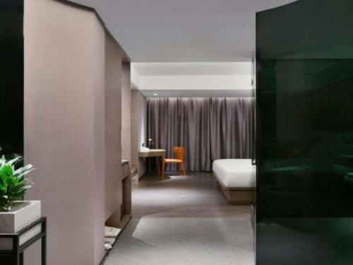 a hotel room with a bed and a desk at Mercure Guilin Hi Tech Zone in Guilin