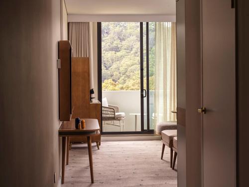 a room with a view of a living room with a window at voco Gosford by IHG in Gosford