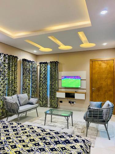 a hotel room with two beds and a tv at GRACE LODGE LEKKI Phase 1 in Araromi