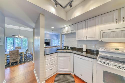 a kitchen with white cabinets and a dining room at St Andrews Common 1975 in Hilton Head Island