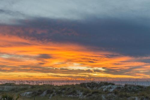 a sunset on the beach with a cloudy sky at St Andrews Common 1975 in Hilton Head Island