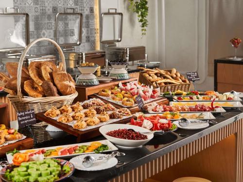 a buffet with a lot of different types of food at Mövenpick Samarkand in Samarkand